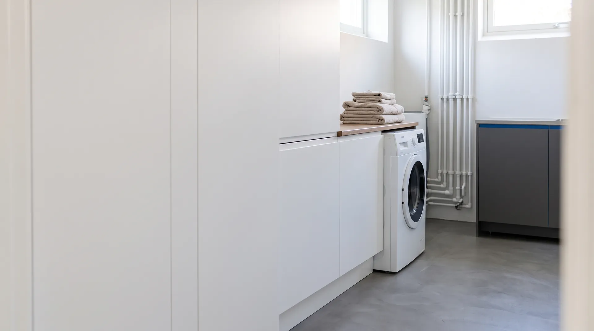 Modern ljus tvättstuga med tvättmaskin
